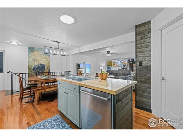 a kitchen with a sink a stove and chairs