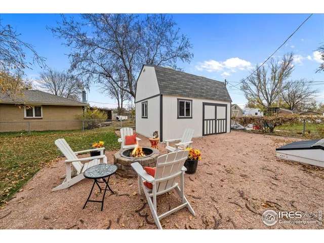 a backyard of a house with table and chairs