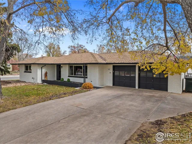 a front view of a house with a garden and yard