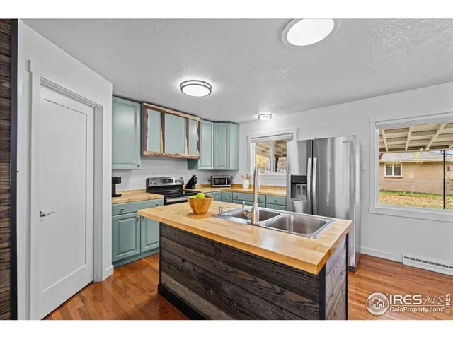 a kitchen with a sink cabinets and window