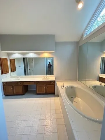 a spacious bathroom with a tub and shower