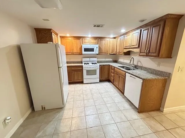 a kitchen with a refrigerator sink and stove