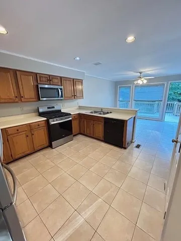 a kitchen with stainless steel appliances kitchen island granite countertop a sink and cabinets