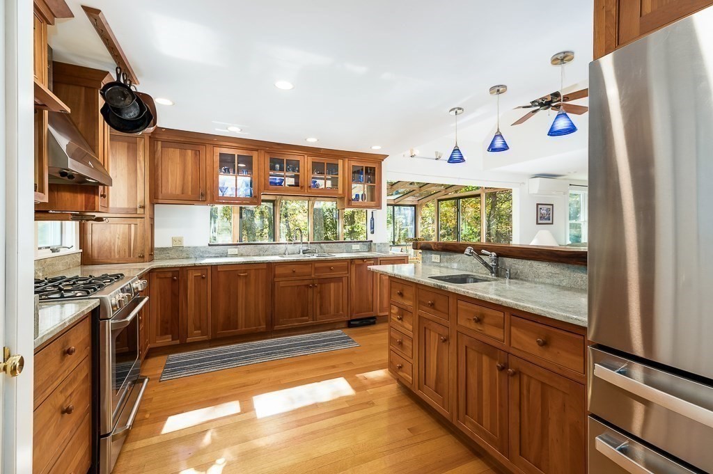 8 Mill Road Ipswich, MA 01938 - Photo 12 of 38 a kitchen with stainless steel appliances granite countertop a stove and a sink