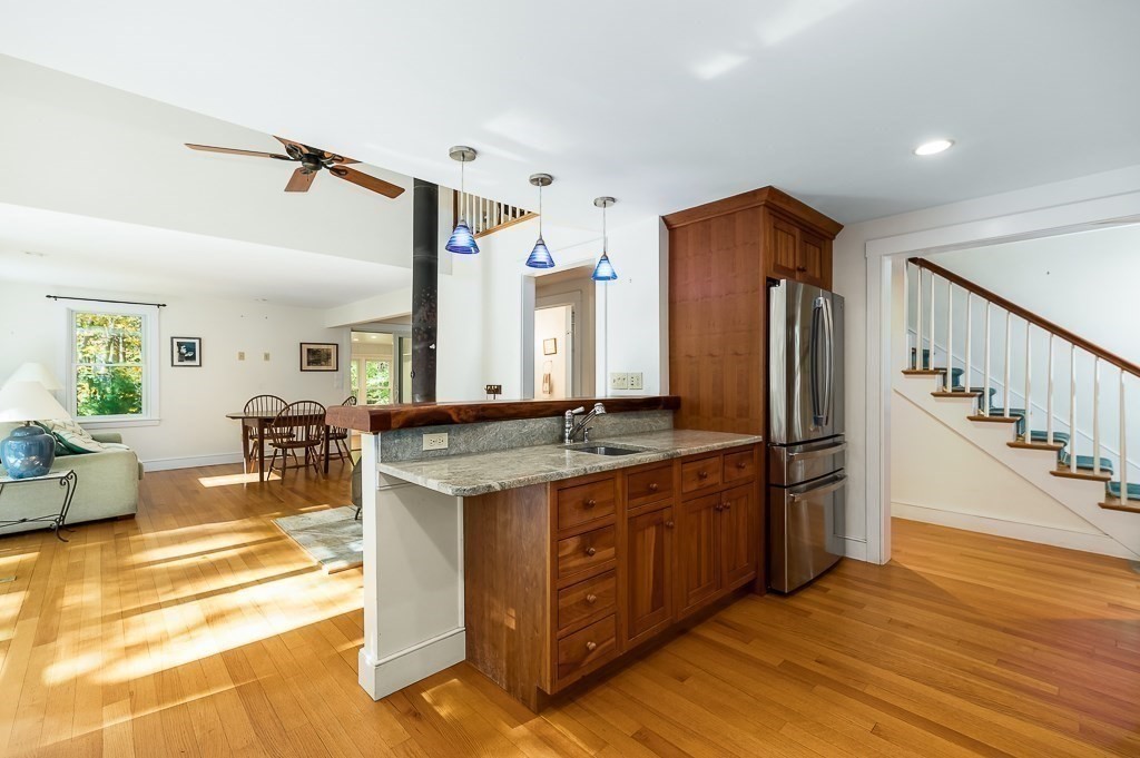 8 Mill Road Ipswich, MA 01938 - Photo 13 of 38 a kitchen with stainless steel appliances granite countertop a refrigerator a stove and a wooden floors
