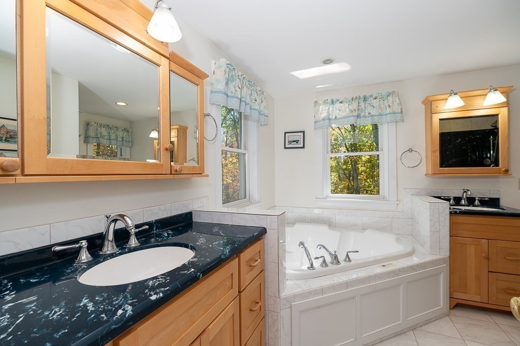8 Mill Road Ipswich, MA 01938 - Photo 25 of 38 a bathroom with a granite countertop sink and a bathtub