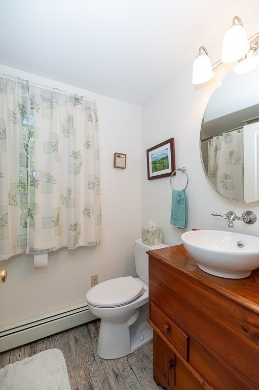 8 Mill Road Ipswich, MA 01938 - Photo 26 of 38 a bathroom with a toilet a sink and mirror