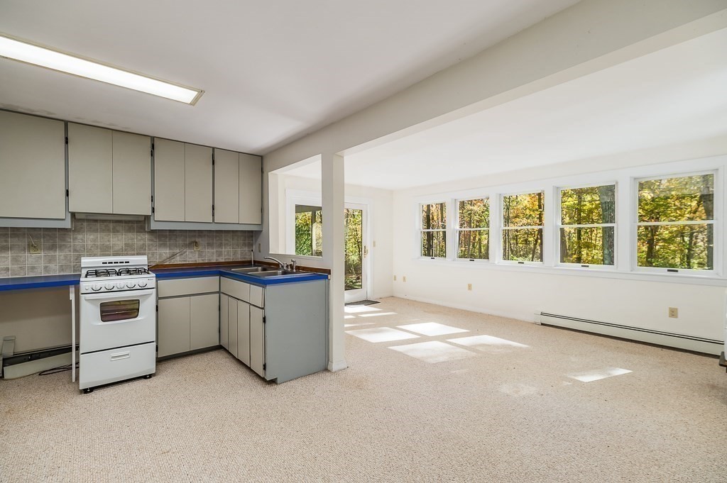 8 Mill Road Ipswich, MA 01938 - Photo 30 of 38 a kitchen with granite countertop a stove and a sink
