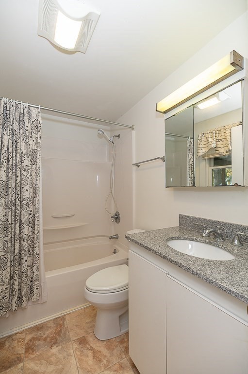 8 Mill Road Ipswich, MA 01938 - Photo 32 of 38 a bathroom with a granite countertop sink mirror vanity and toilet