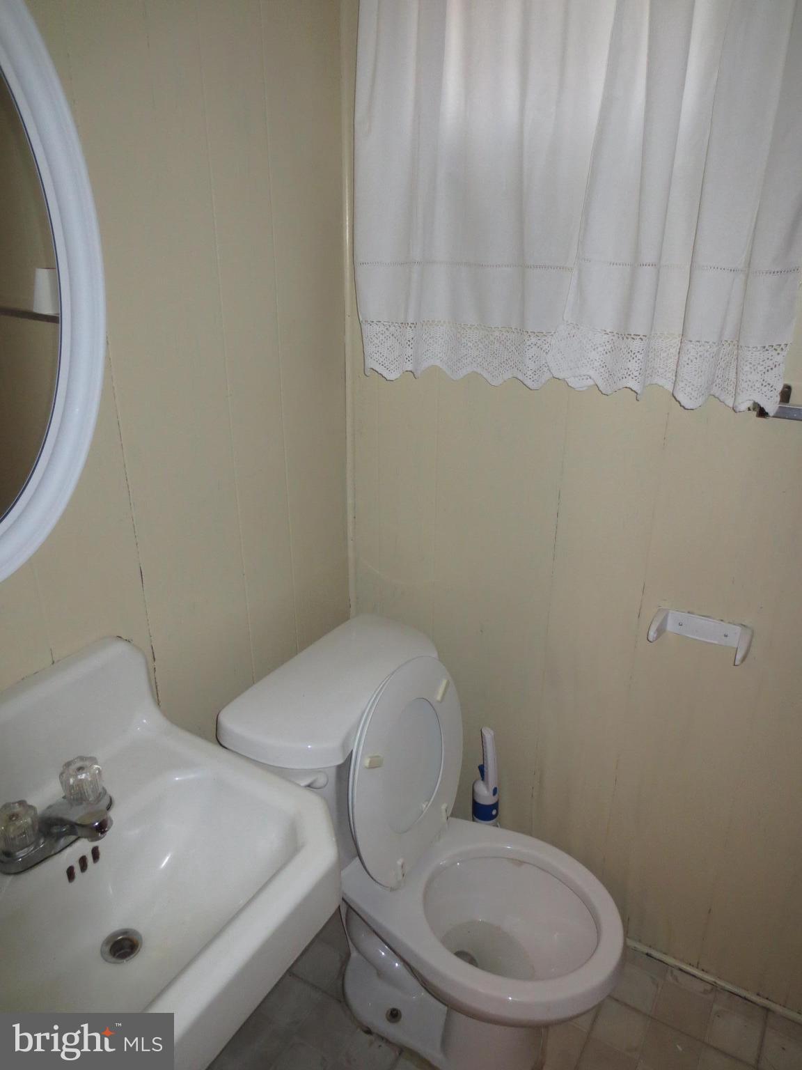 3705 May Street Silver Spring, MD 20906 - Photo 18 of 27 a white toilet sitting next to a bathroom sink