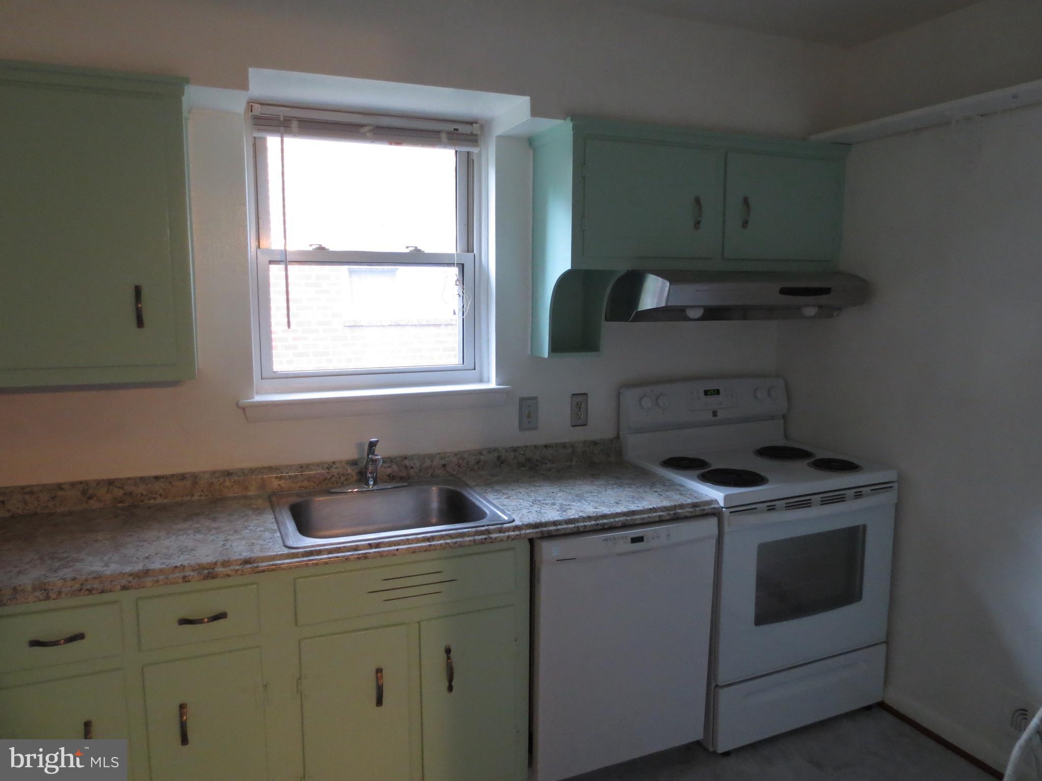 3705 May Street Silver Spring, MD 20906 - Photo 7 of 27 a kitchen with cabinets a stove and a sink