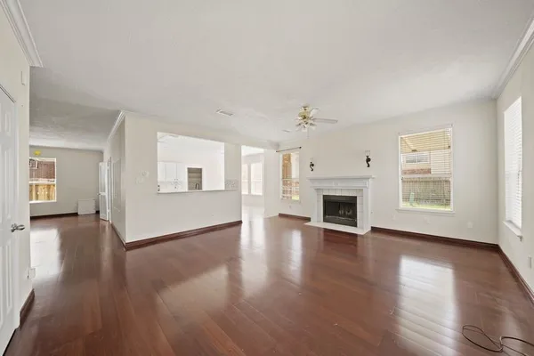 a view of a livingroom with wooden floor and a fireplace