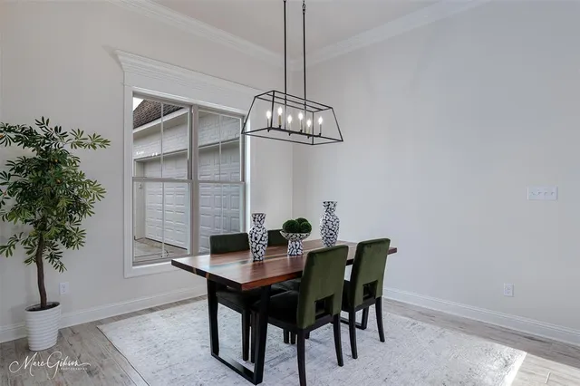 a dining room with a table and chairs