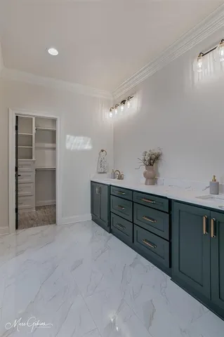 a bathroom with a sink double vanity granite tub and a mirror