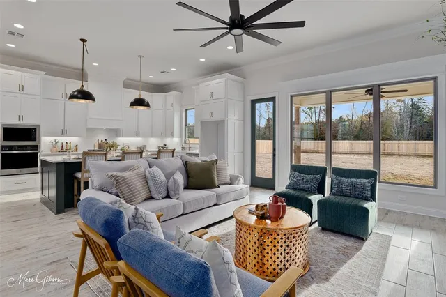 a living room with furniture and a large window