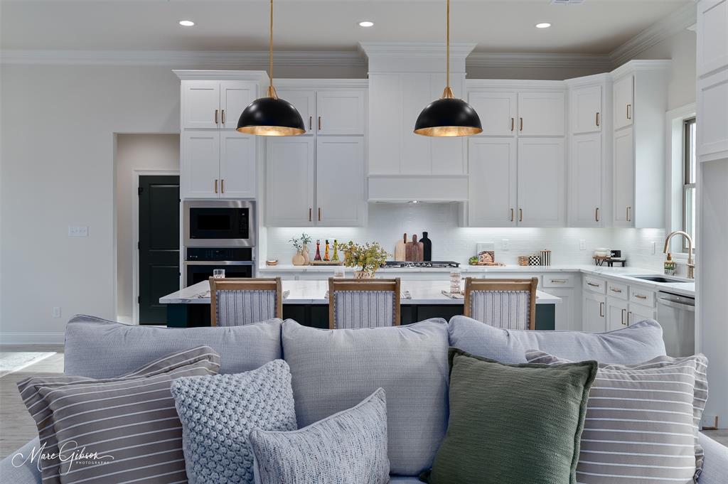 175 Sitka Loop Haughton, LA 71037 - Photo 6 of 28 a kitchen with stainless steel appliances granite countertop a stove a sink a microwave a refrigerator and white cabinets