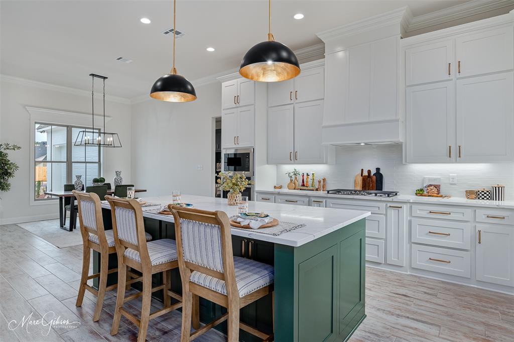 175 Sitka Loop Haughton, LA 71037 - Photo 9 of 28 a kitchen with a dining table cabinets and appliances
