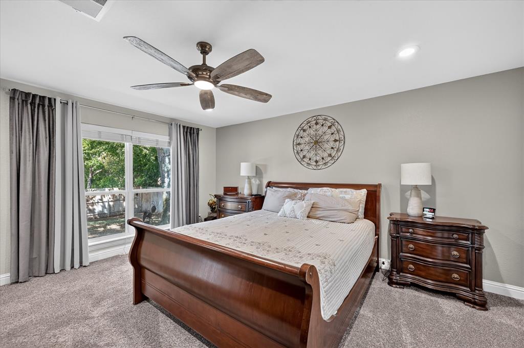 47 Bounty Road East Benbrook, TX 76132 - Photo 16 of 39 Spacious room featuring plush carpet flooring, a large window with exterior views, and a ceiling fan