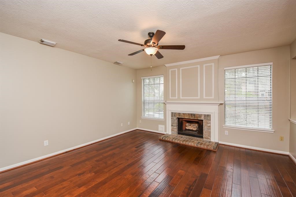 27 West Rumple Creek Place Spring, TX 77381 - Photo 8 of 32 Appreciate a gas log fireplace to cozy up to on cool evenings.