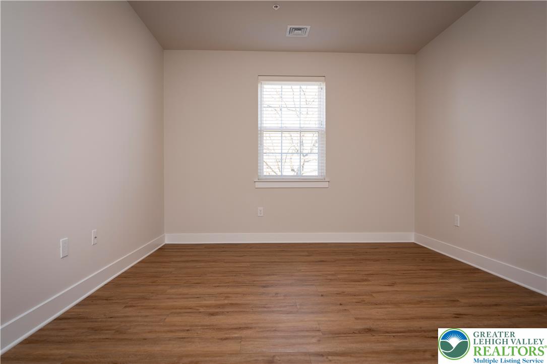 1763 Madison Avenue, Unit 201 Bethlehem, PA 18017 - Photo 11 of 20 wooden floor in an empty room with a window