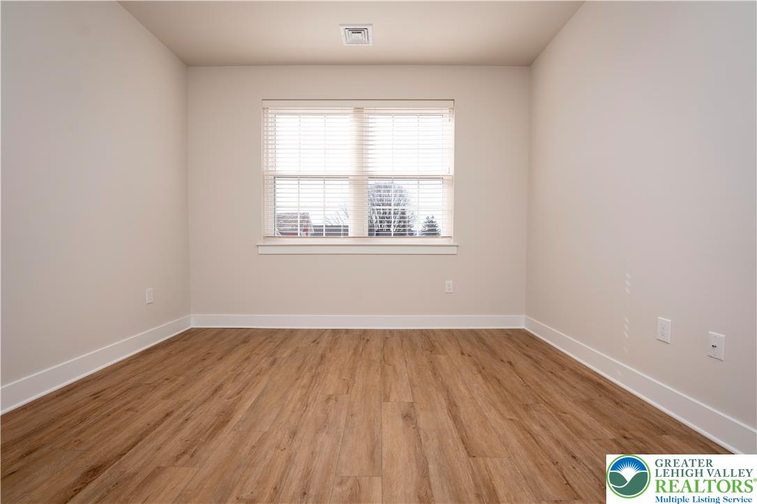 1763 Madison Avenue, Unit 201 Bethlehem, PA 18017 - Photo 14 of 20 an empty room with wooden floor and windows