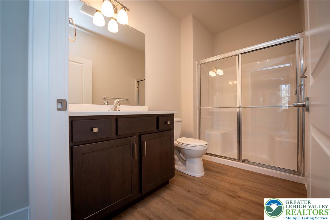 1763 Madison Avenue, Unit 201 Bethlehem, PA 18017 - Photo 16 of 20 a bathroom with a toilet a sink and mirror