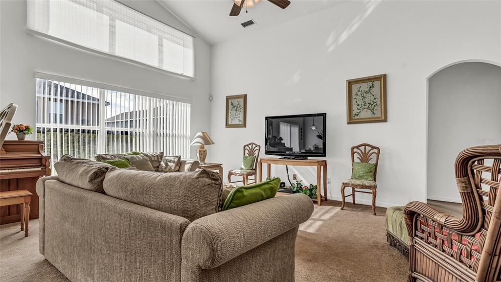 1153 Legatto Loop Dundee, FL 33838 - Photo 11 of 48 a living room with furniture a flat screen tv and a window