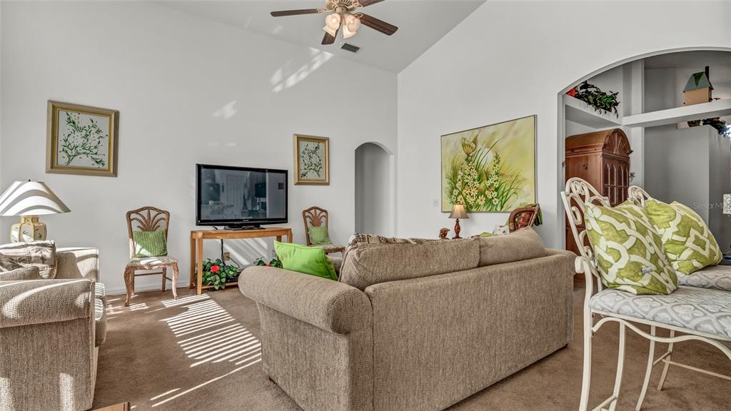 1153 Legatto Loop Dundee, FL 33838 - Photo 12 of 48 a living room with furniture and a flat screen tv