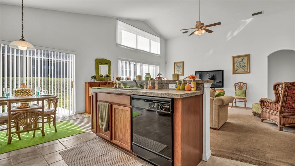 1153 Legatto Loop Dundee, FL 33838 - Photo 15 of 48 a kitchen that has a lot of cabinets in it and a dining table