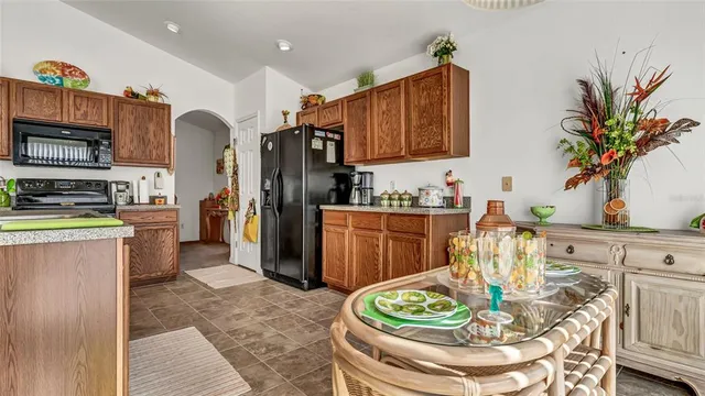 a kitchen with stainless steel appliances granite countertop a refrigerator and a stove top oven