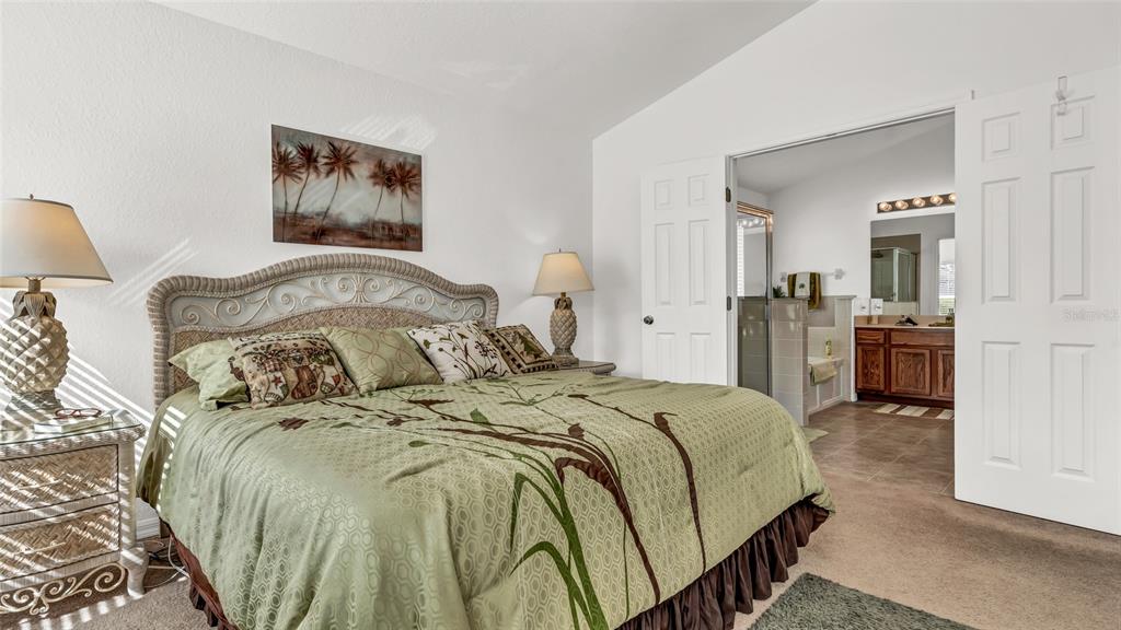 1153 Legatto Loop Dundee, FL 33838 - Photo 20 of 48 a bedroom with a bed and a lamp