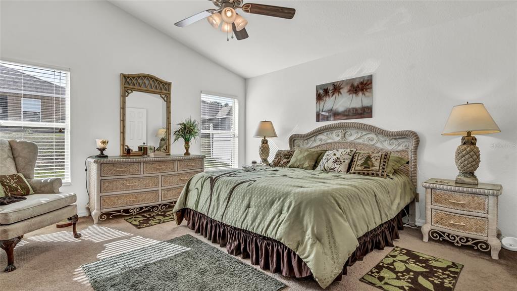 1153 Legatto Loop Dundee, FL 33838 - Photo 22 of 48 a bedroom with a bed and a chandelier