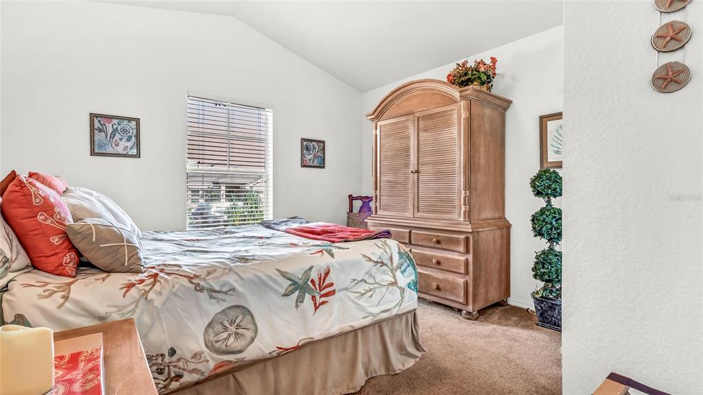 1153 Legatto Loop Dundee, FL 33838 - Photo 28 of 48 a bedroom with a bed and a window