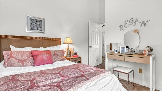 a bedroom with a bed and a mirror