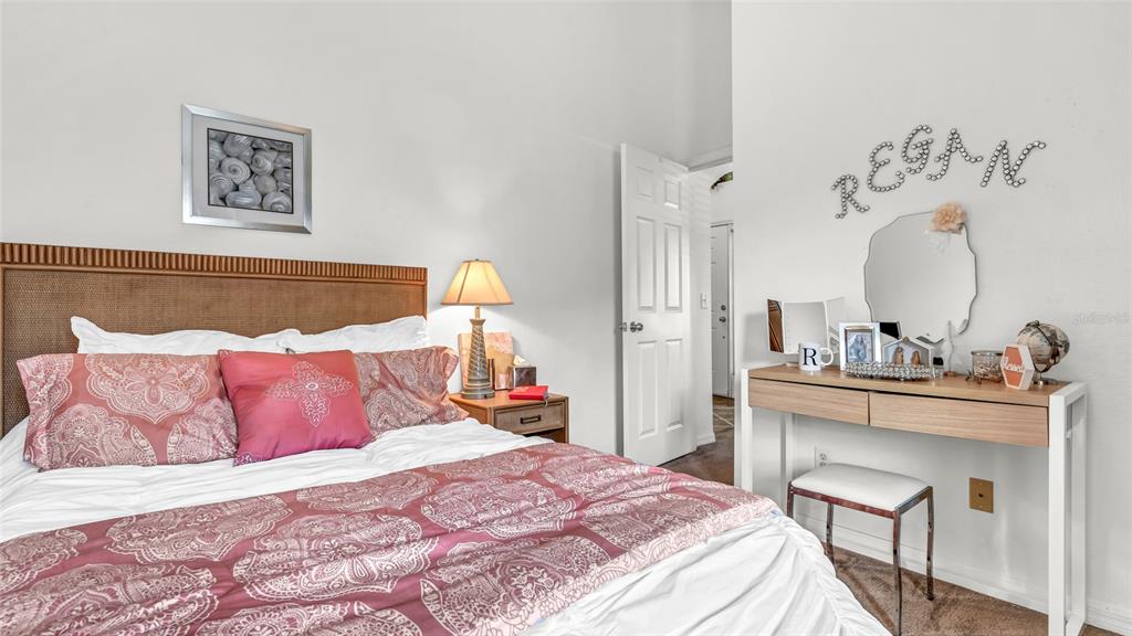 1153 Legatto Loop Dundee, FL 33838 - Photo 30 of 48 a bedroom with a bed and a mirror