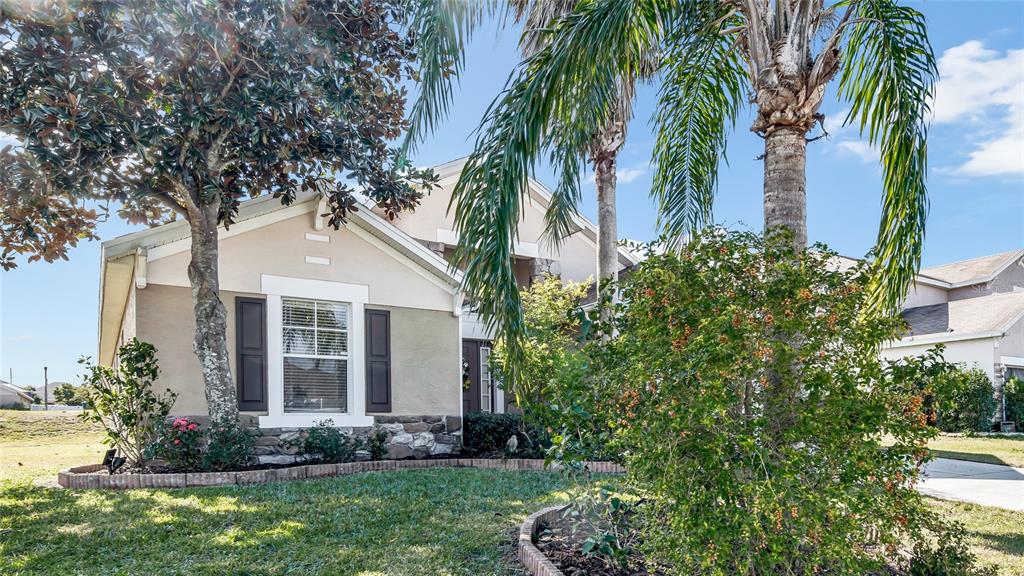1153 Legatto Loop Dundee, FL 33838 - Photo 3 of 48 a front view of house with yard and green space