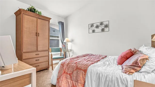 a bedroom with a bed and a dresser