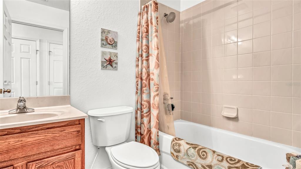 1153 Legatto Loop Dundee, FL 33838 - Photo 32 of 48 a bathroom with a sink a toilet and a bathtub