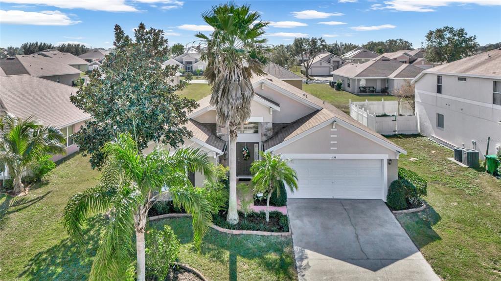 1153 Legatto Loop Dundee, FL 33838 - Photo 40 of 48 a aerial view of a house with a yard and potted plants