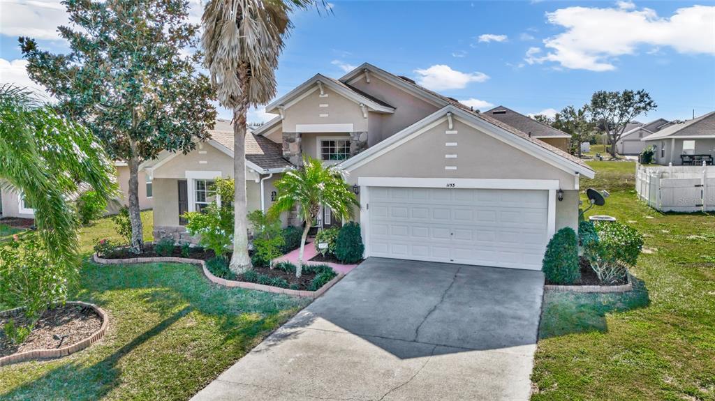 1153 Legatto Loop Dundee, FL 33838 - Photo 42 of 48 front view of a house with a yard