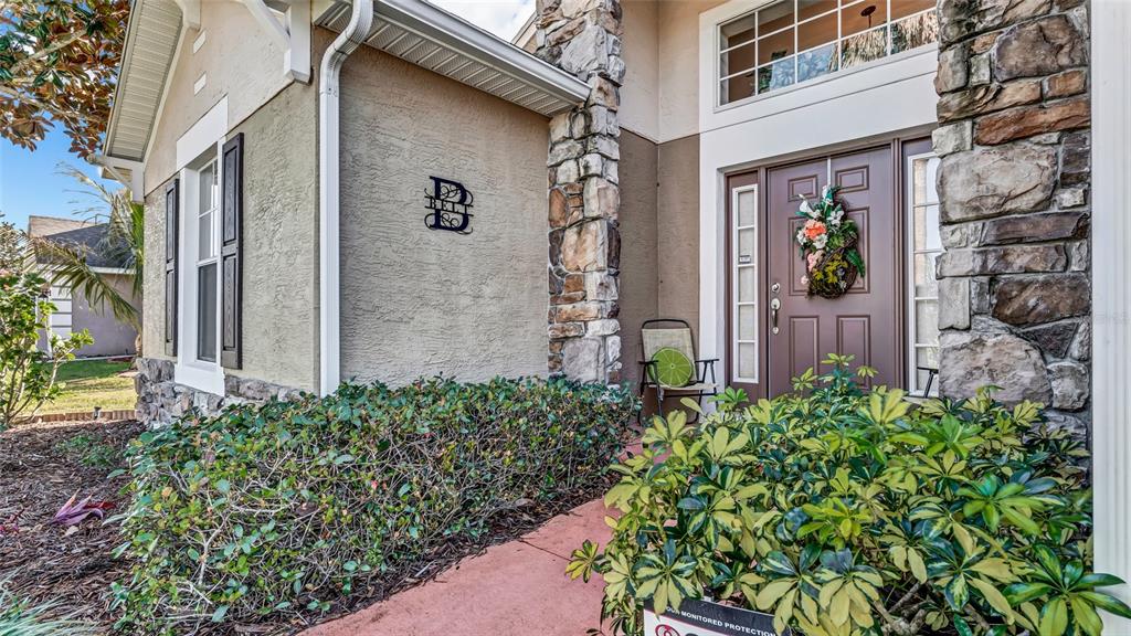 1153 Legatto Loop Dundee, FL 33838 - Photo 5 of 48 a view of a brick house with a flower plants