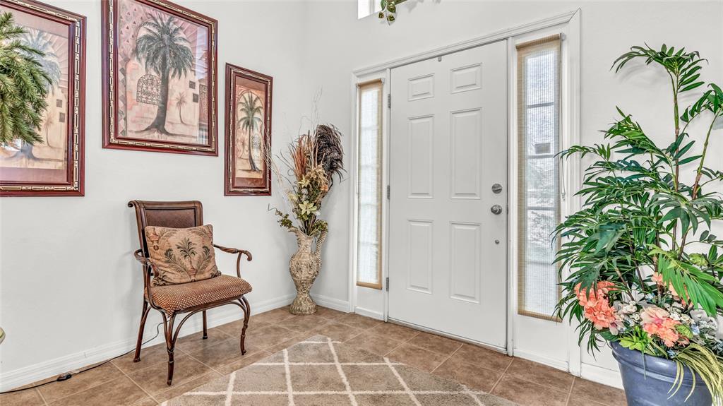 1153 Legatto Loop Dundee, FL 33838 - Photo 6 of 48 a living room with furniture and a potted plant
