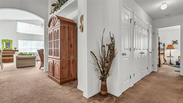 a view of hallway with furniture and a potted plant
