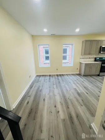 a view of a kitchen with wooden floor