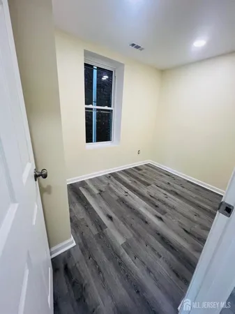 a view of an empty room with windows