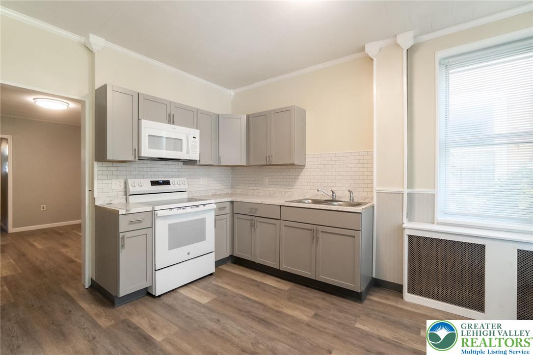421 Center Street Jim Thorpe, PA 18229 - Photo 17 of 34 a kitchen with stainless steel appliances white cabinets and wooden floor