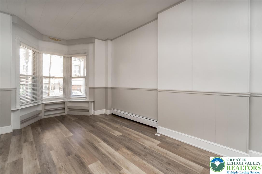 421 Center Street Jim Thorpe, PA 18229 - Photo 6 of 34 an empty room with wooden floor and windows