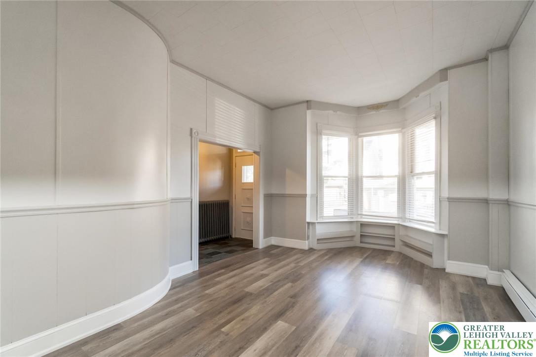 421 Center Street Jim Thorpe, PA 18229 - Photo 7 of 34 an empty room with wooden floor and windows