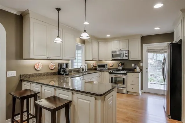 a kitchen with a sink a center island and cabinets