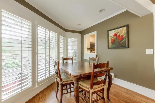 a view of a dining room with furniture large window and wooden floor